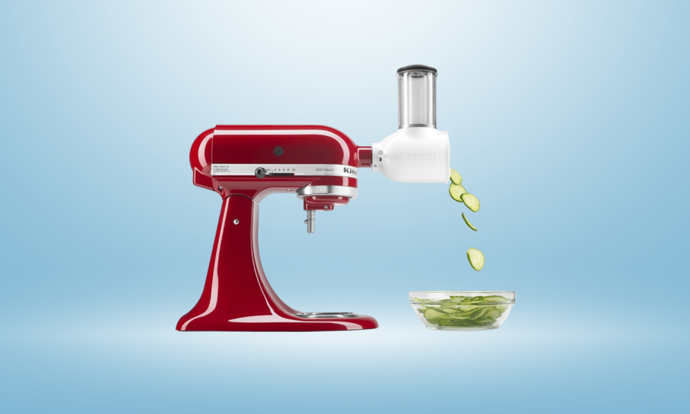 KitchenAid-Küchenmaschine in rot mit Schneideaufsatz mit Gurken, die in eine Schüssel fallen | © Amazon