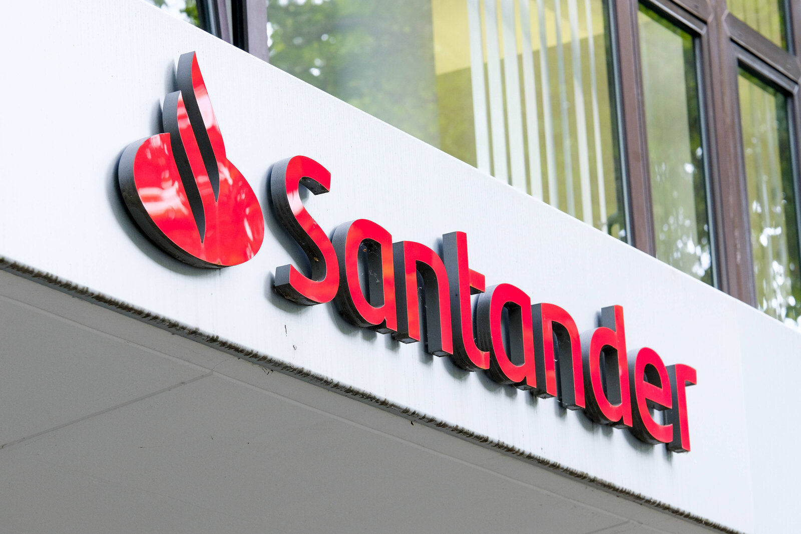 Roter Schriftzug der Santander Consumer Bank.  | © IMAGO / Michael Gstettenbauer